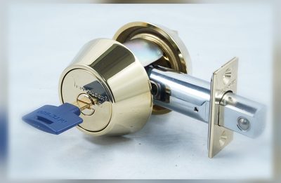 High-security deadbolt showing the steel bolt and faceplate that hold a front door shut against force