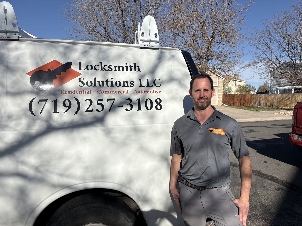 Eyal from Locksmith Solutions LLC beside the mobile locksmith van